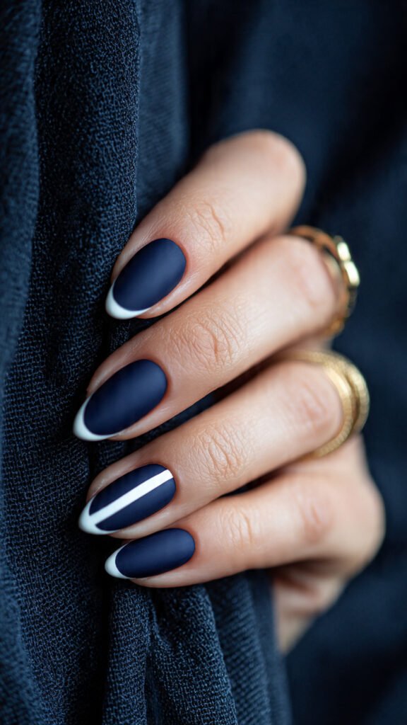 matte navy base paired with glossy white accents nail art