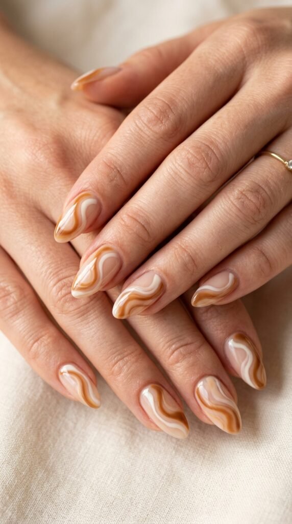 Hands_with_caramel_swirl_nails_202608041709 Hands with caramel swirl nails 202608041709 fall nail ideas